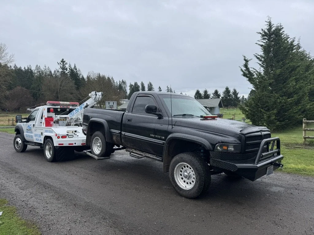 Safe Vehicle Transport Pacific Towing & Recovery flatbed tow truck safely transporting an SUV in Pacific, Washington